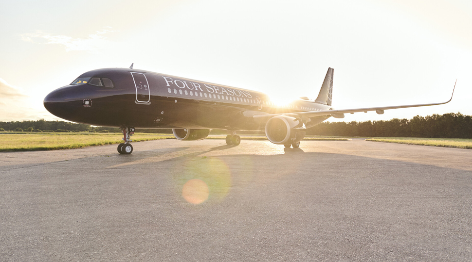Black private jet with Four Seasons branding