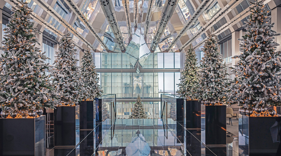 Large atrium lined with holiday trees