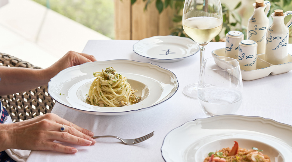 Pasta dish served on a white-linen table
