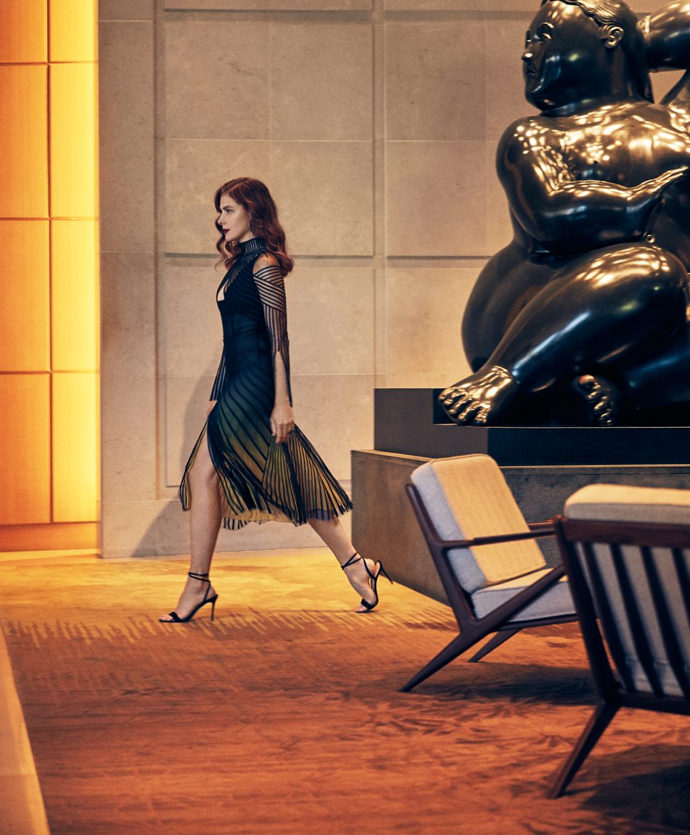 Woman walking through a hotel lobby