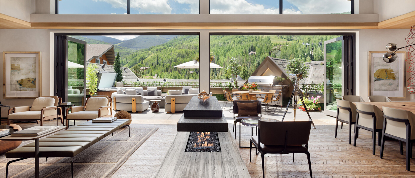 Mountain view from the large windows of a chic, modern living area