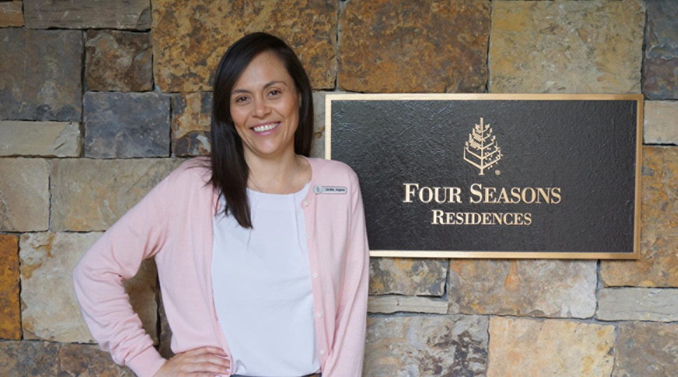 Carolina Angarita, Director of Private Residences, Four Seasons Resort and Residences Vail, poses next to a Four Seasons Residences sign