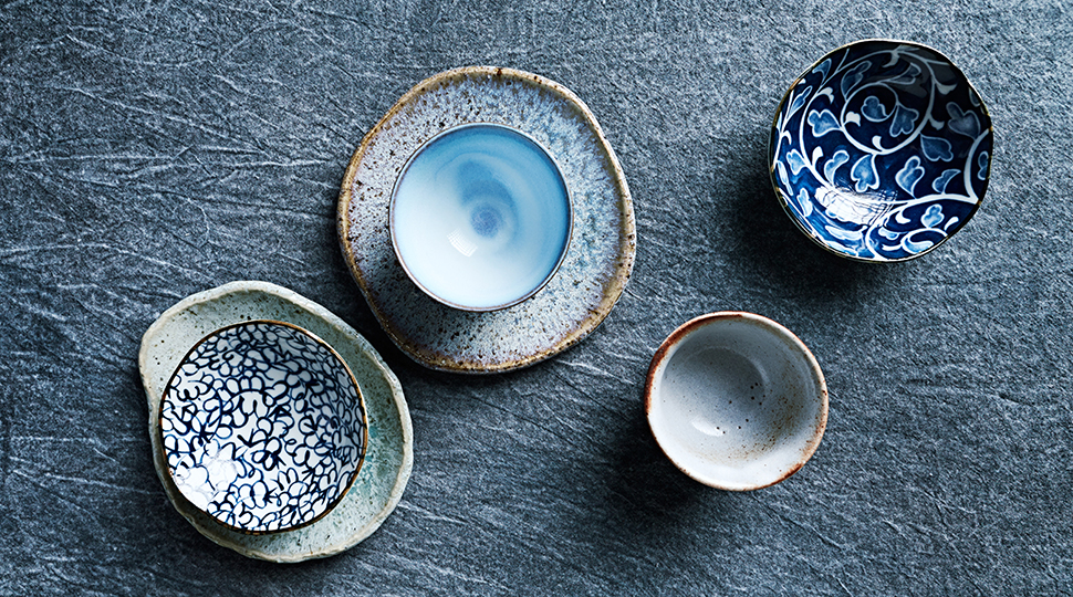 Blue Toned Ceramic Dishware On Indigo Cloth. Flat Lay. Hand Crafted Ceramic. Copy Space