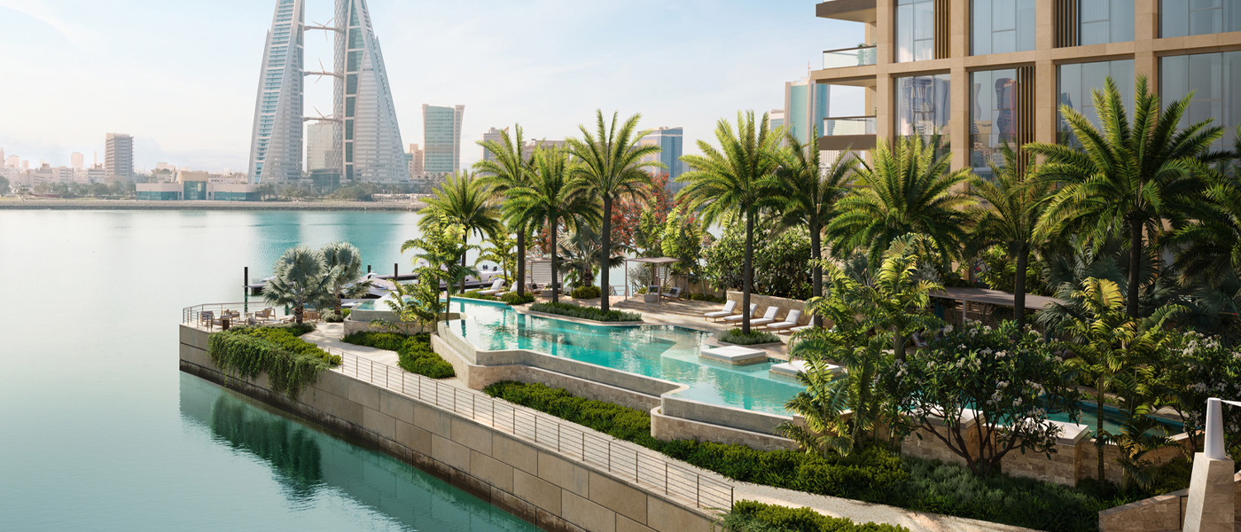 Palm-fringed outdoor pool set on a terrace next to the river