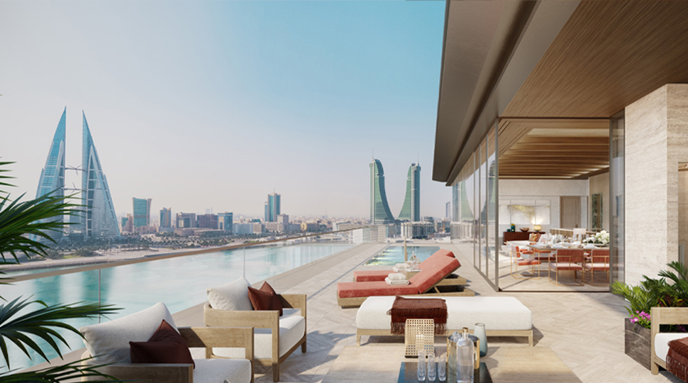 Lounge chairs on a pool deck overlooking the city skyline