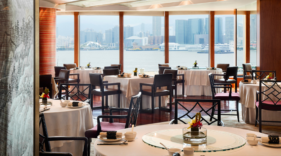 Interior of restaurant with windows that overlook a harbour