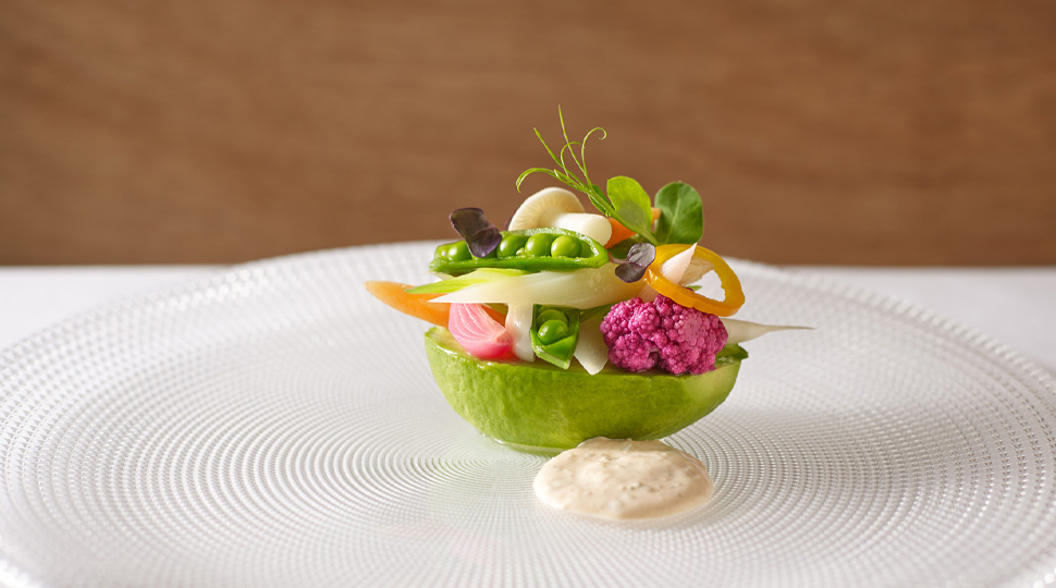 Thomas Keller's Avocado Louie dish with half an avocado stacked with a variety of colourful toppings