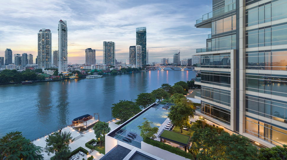 Side of a skyscraper with a pool, deck and riverfront views