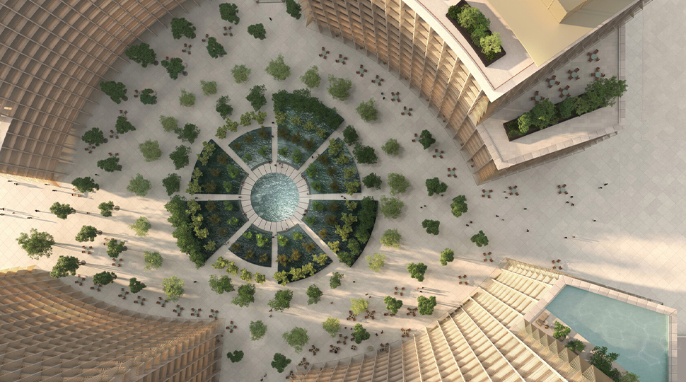 Aerial view of landscaped plaza set in between four curbed-edge buildings