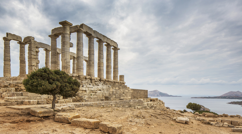 Ruins of ancient temple on a hillside overlooking the sea