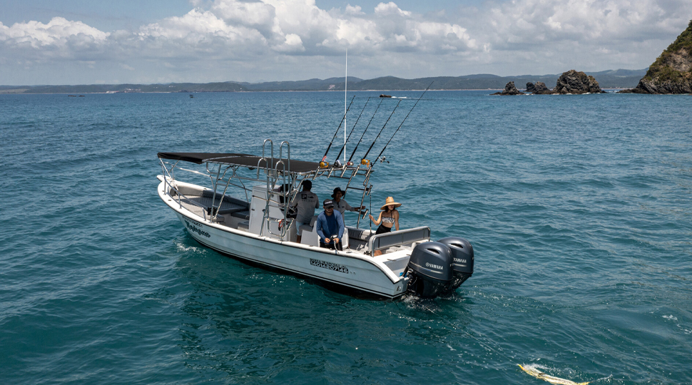 Fishing boat anchored in blue-green waters