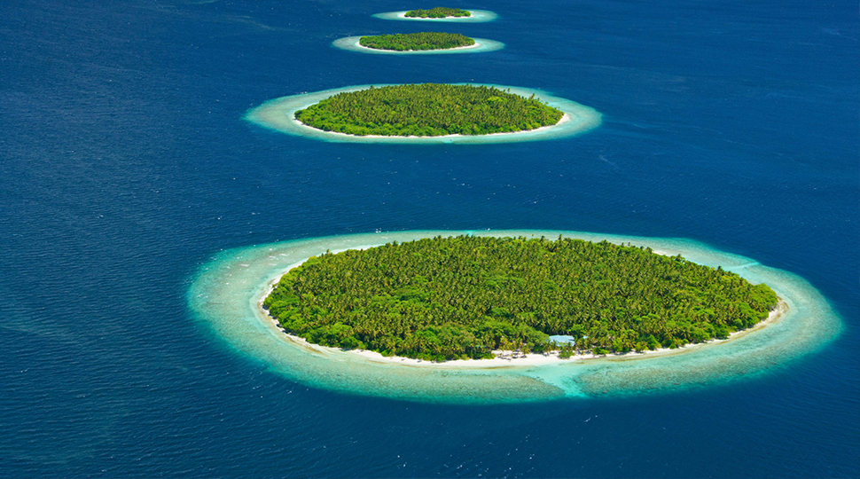 Four round islands punctuate a bright blue ocean